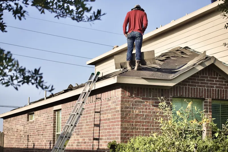 Professional roofer working on a residential roof in Babylon